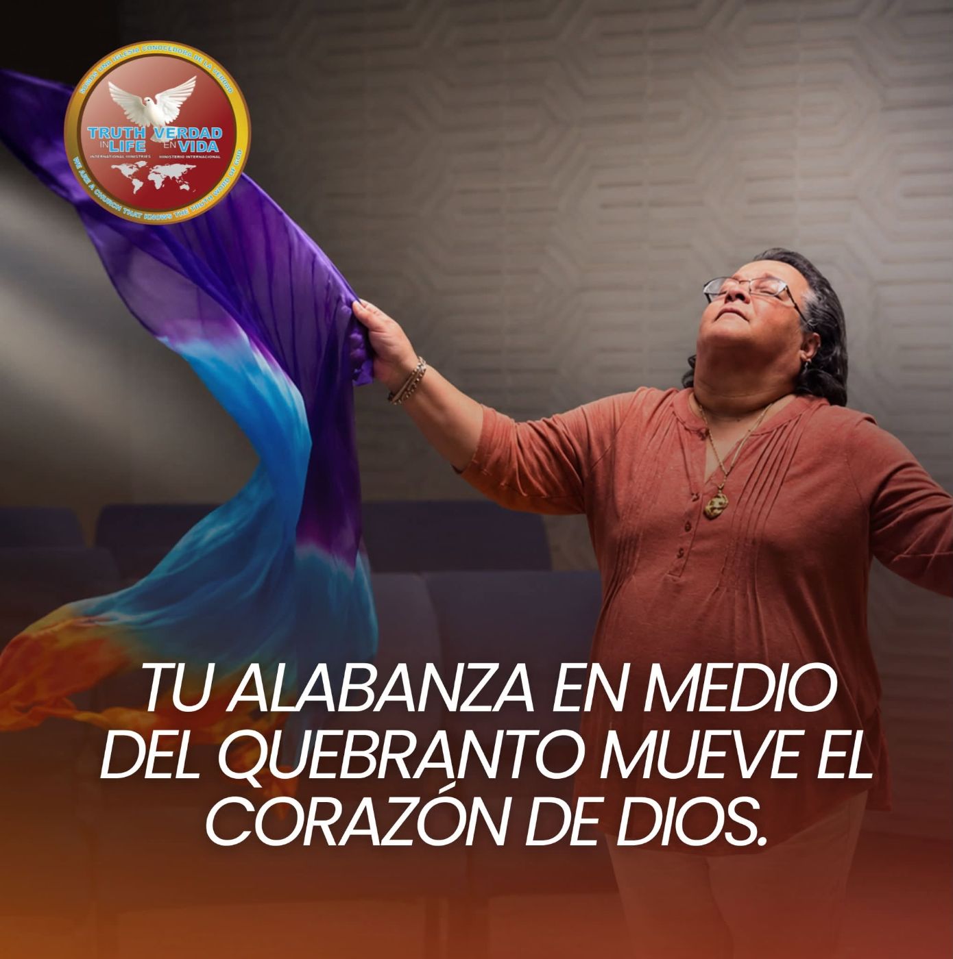 Woman holding colorful fabric with "Truth Verdad Life Vida" logo, Spanish motivational text overlay